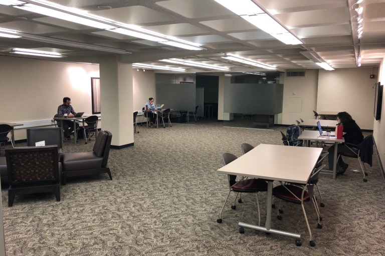 Graduate students working at tables in the Grad Commons.