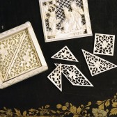 White tangram tiles on a black background